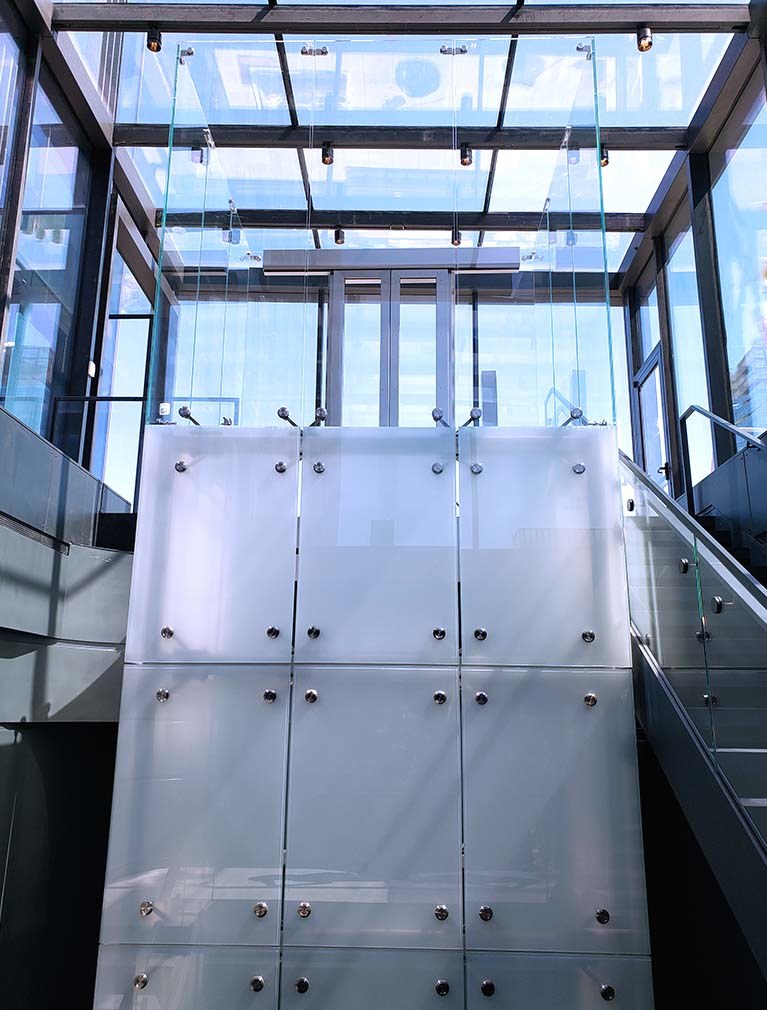 Clear Glass elevator landing in glass alcove