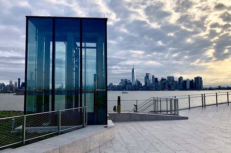 Liberty Island Museum Glass Elevator with the NYC skyline in the background