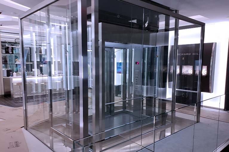 Custom Elevator installation glass and stainless steel with beveled edges