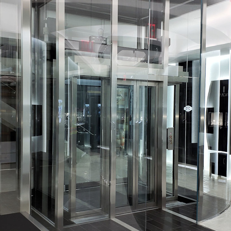 Custom glass elevator at Richard Mille, beveled steel and glass