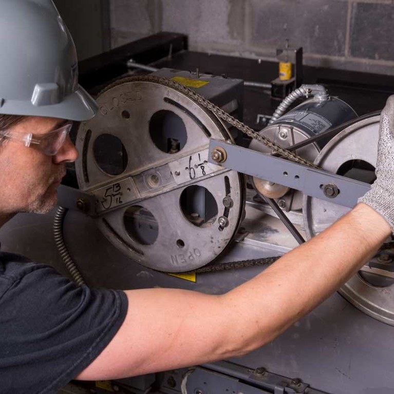 Maintenance Technician repairing elevator equipment